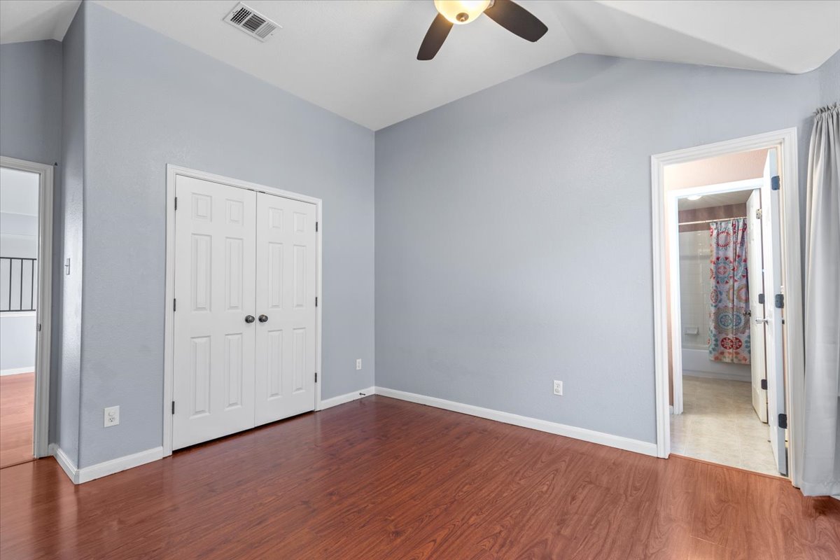 3523 Cheyenne Street Round Rock, TX 78665 - Photo 19 of 34 Unfurnished bedroom with dark wood-type flooring, a ceiling fan, a closet, and ensuite bathroom