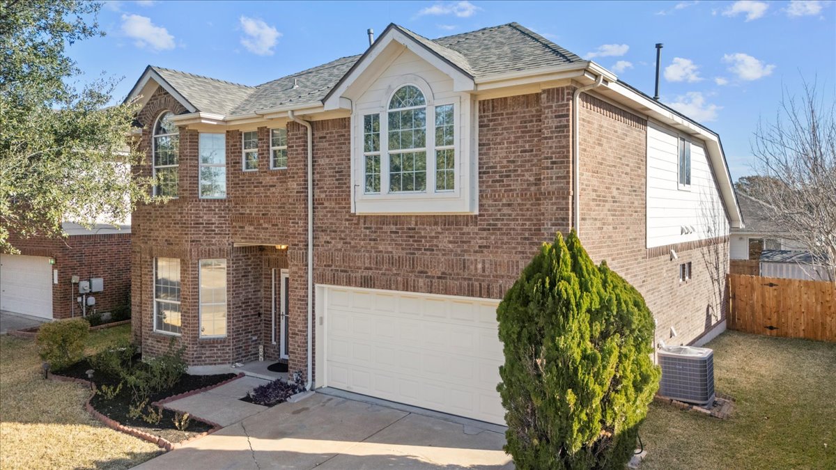 3523 Cheyenne Street Round Rock, TX 78665 - Photo 2 of 34 View of front facade featuring brick siding, driveway, and a garage
