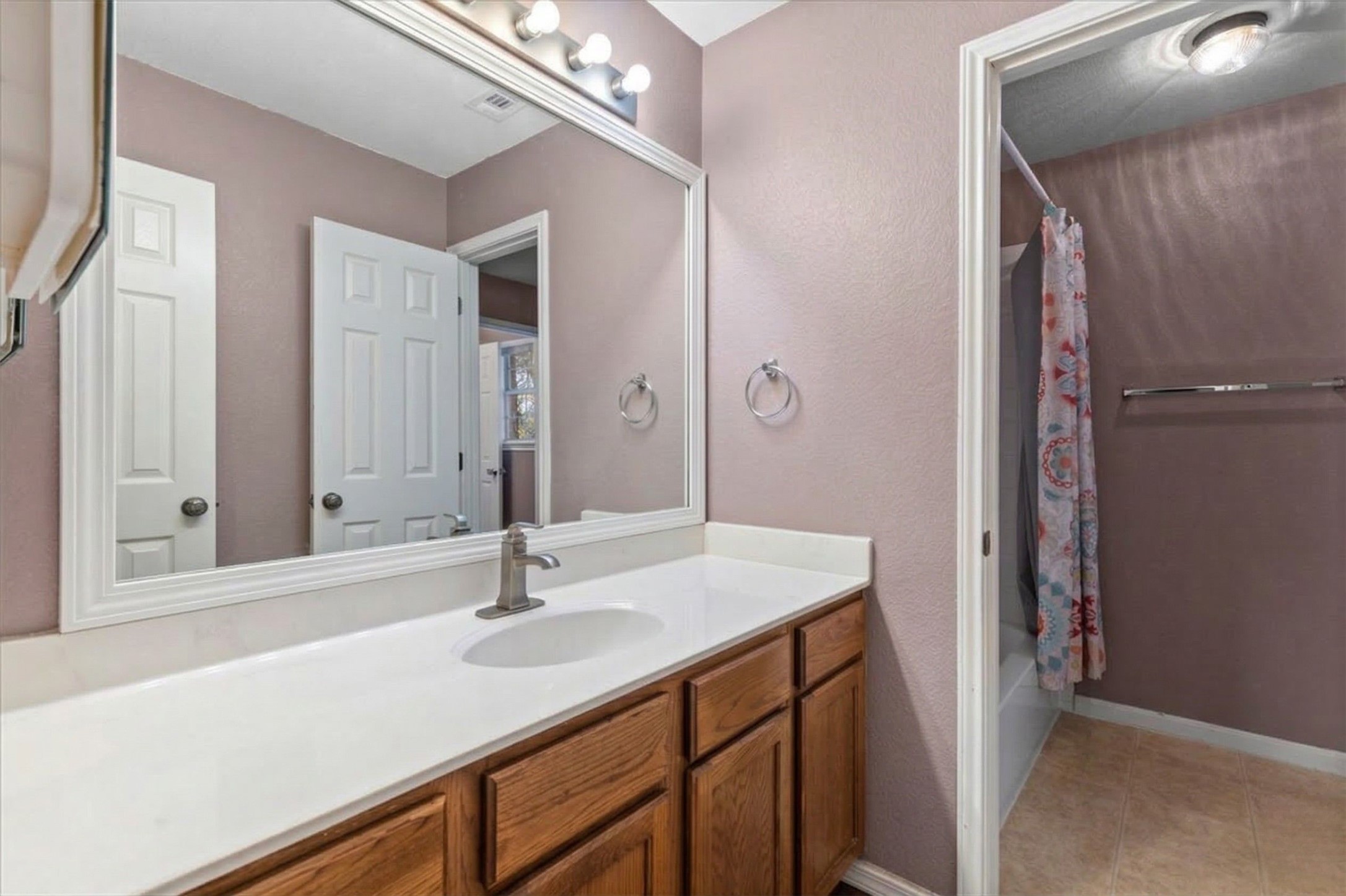 3523 Cheyenne Street Round Rock, TX 78665 - Photo 21 of 34 Full bathroom with vanity, a textured wall, shower / bath combo, and light tile patterned flooring