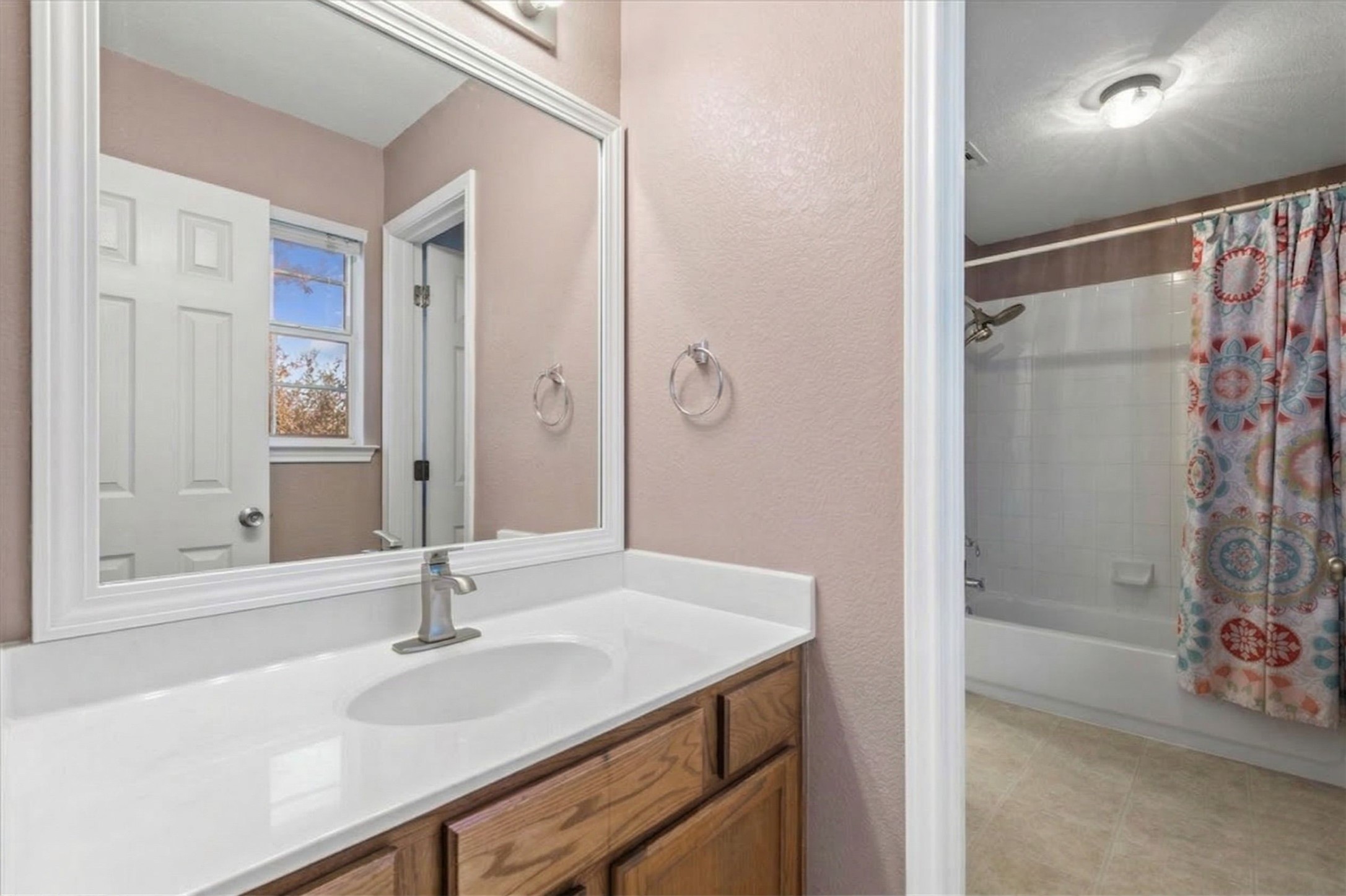 3523 Cheyenne Street Round Rock, TX 78665 - Photo 22 of 34 Bathroom with shower / bath combo, vanity, and a textured wall