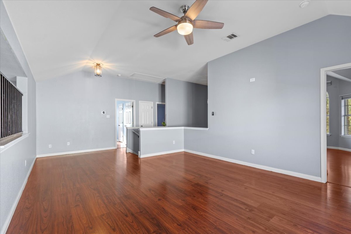 3523 Cheyenne Street Round Rock, TX 78665 - Photo 26 of 34 Unfurnished living room featuring dark wood-style floors and a ceiling fan