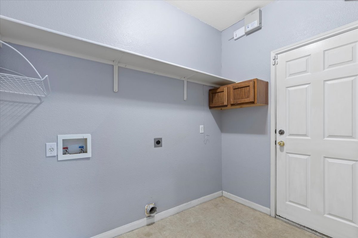 3523 Cheyenne Street Round Rock, TX 78665 - Photo 28 of 34 Laundry room featuring electric dryer hookup, hookup for a washing machine, and light flooring