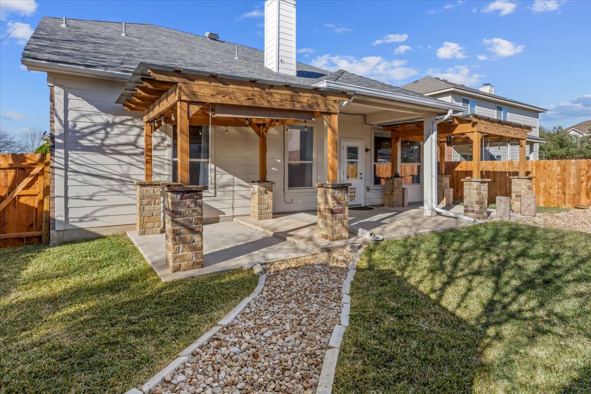 3523 Cheyenne Street Round Rock, TX 78665 - Photo 29 of 34 Back of property featuring a fenced backyard, a chimney, a patio, a gate, and roof with shingles