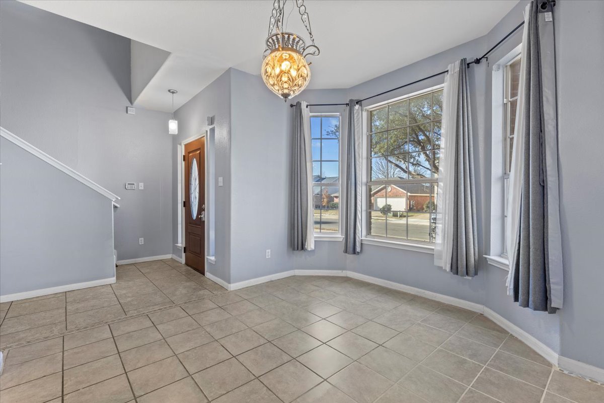 3523 Cheyenne Street Round Rock, TX 78665 - Photo 4 of 34 Unfurnished dining area featuring suspended lighting and light tile patterned flooring