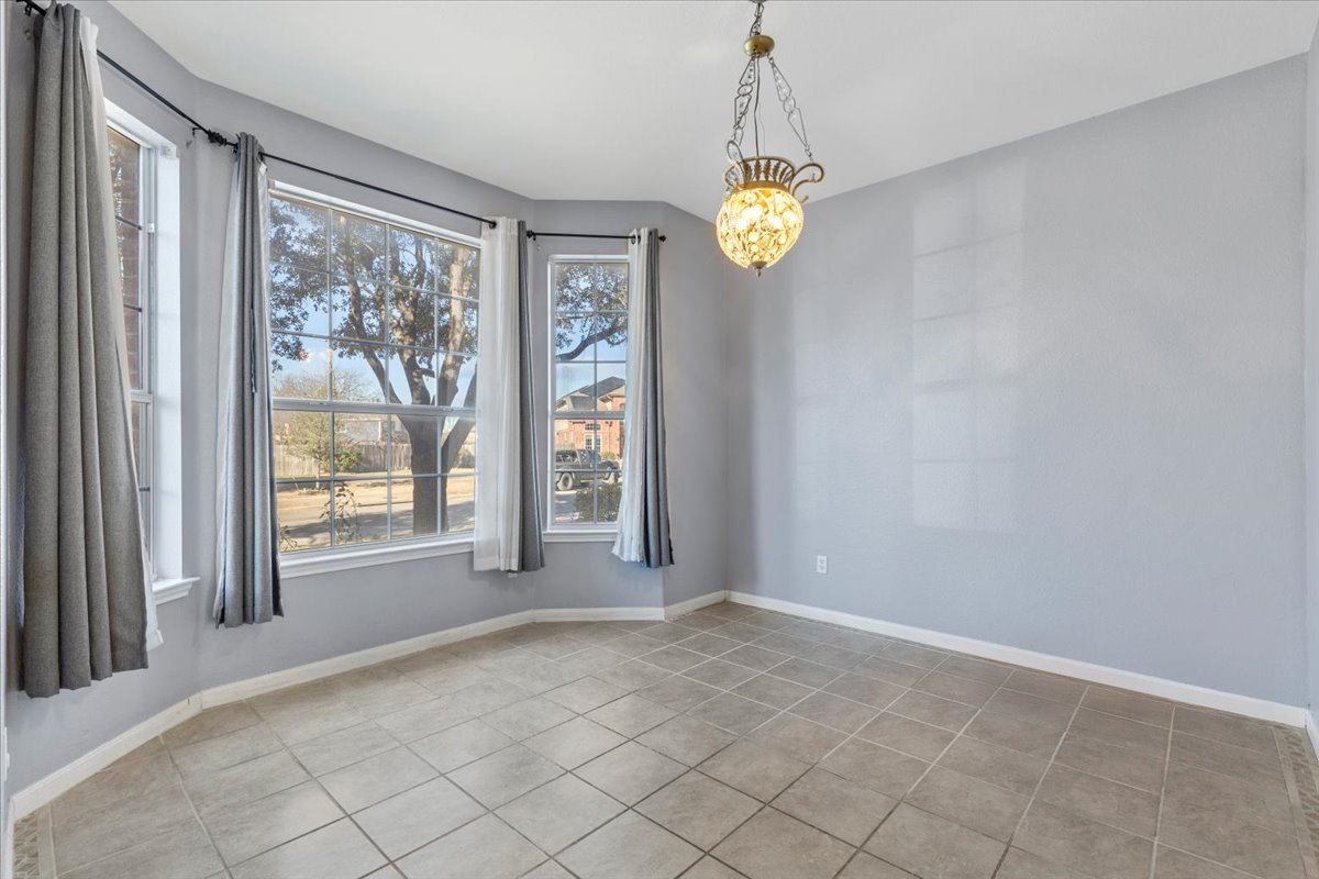 3523 Cheyenne Street Round Rock, TX 78665 - Photo 6 of 34 Unfurnished dining area with a chandelier and light tile patterned floors