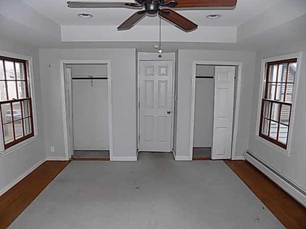 56 Fairview Avenue Chicopee, MA 01013 - Photo 21 of 22 an empty room with windows and ceiling fan