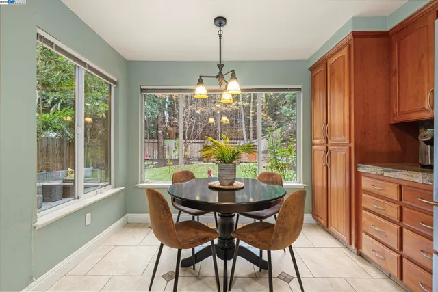 a dining room with furniture a chandelier and wooden floor