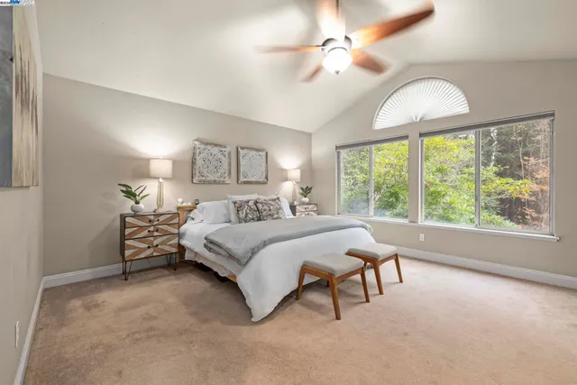 a spacious bedroom with a bed and a chandelier