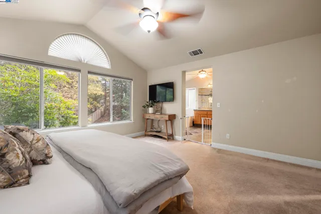 a bed room with a bed and a chair