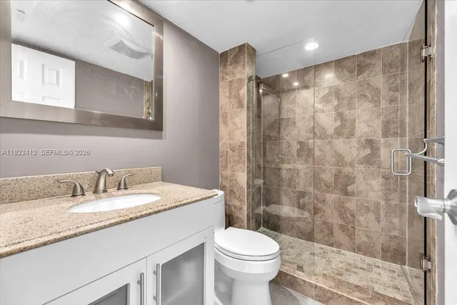 a kitchen with stainless steel appliances granite countertop a kitchen stove a sink and a refrigerator