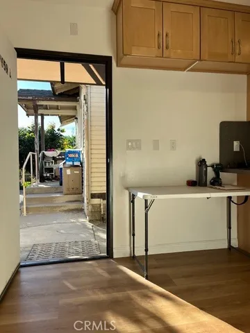 a view of a room with wooden floor and furniture