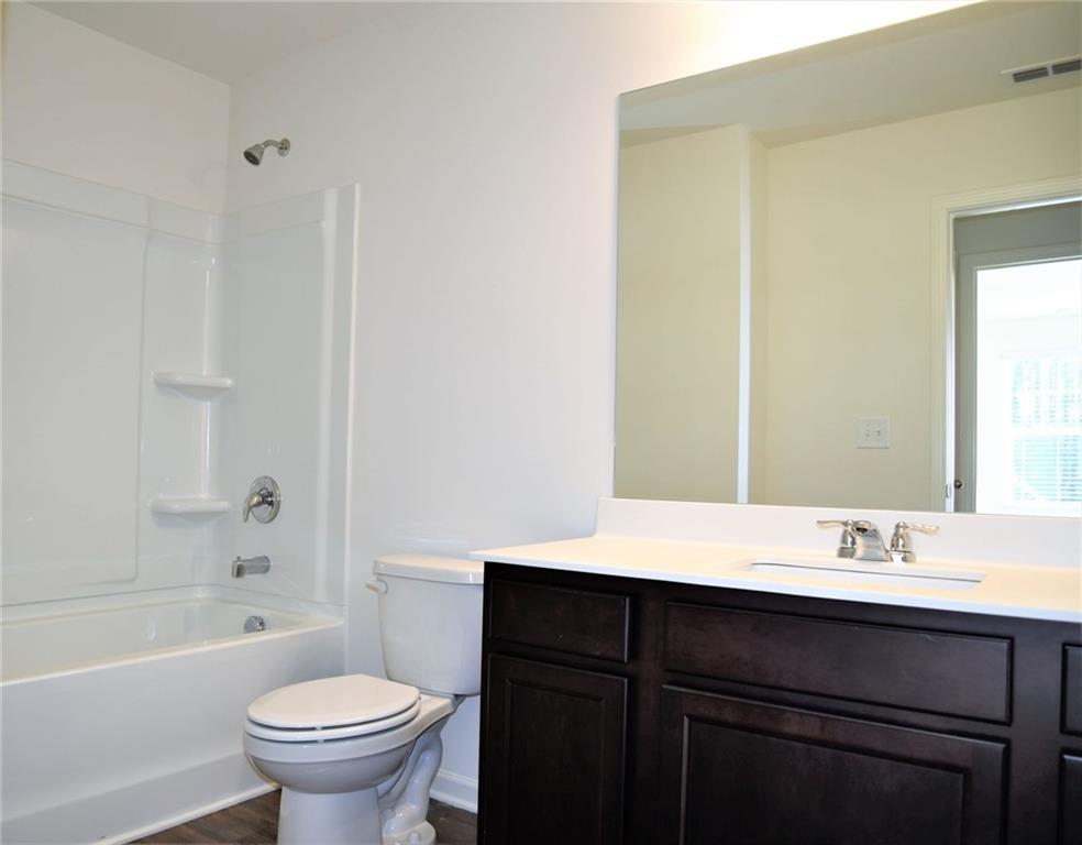 4374 Kendrick Circle Loganville, GA 30052 - Photo 21 of 25 a bathroom with a sink and a mirror