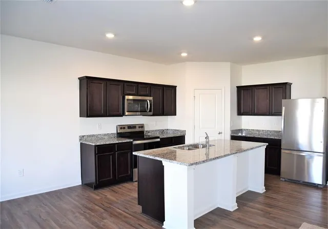a kitchen with a sink stove and refrigerator