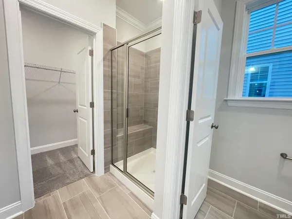 a bathroom with a glass shower door