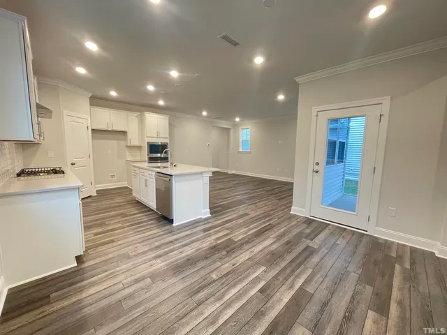 a view of kitchen with wooden floor and electronic appliances