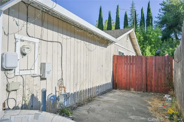 a view of a street with wooden fence