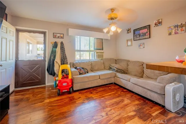 a living room with furniture and wooden floor