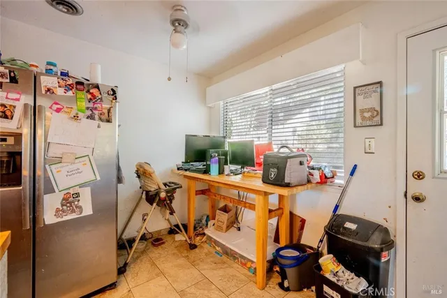 a view of a workspace with furniture and a window