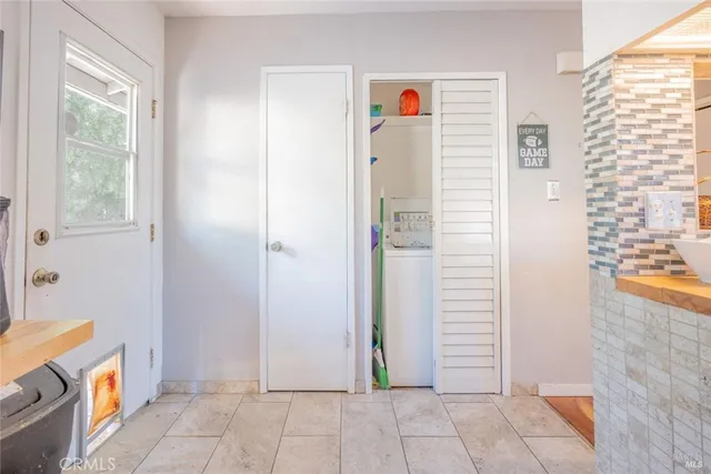 a view of an entryway with wooden floor and a livingroom