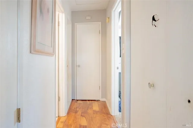 a view of a bathroom from a corridor