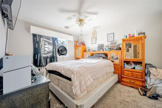 a spacious bedroom with a bed and a chandelier