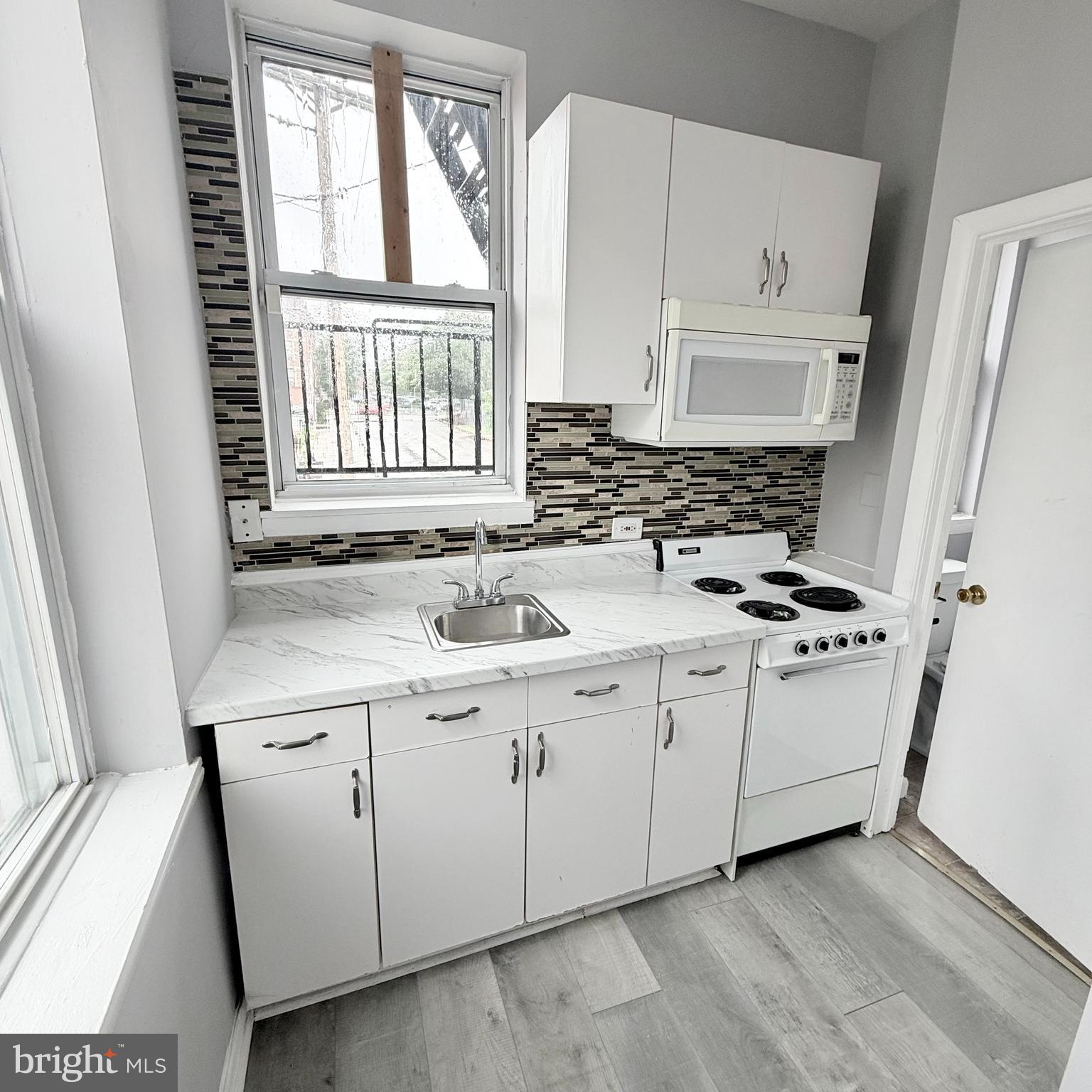 1001 Light Street, Unit 2 Baltimore, MD 21230 - Photo 10 of 11 a kitchen with stainless steel appliances white cabinets and a sink