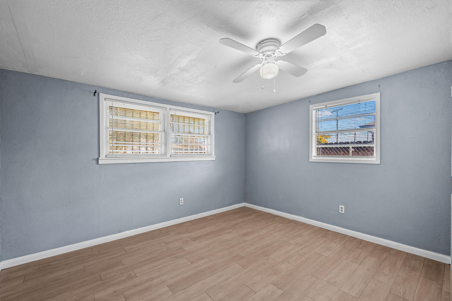 3409 East 17th Street Lubbock, TX 79403 - Photo 14 of 24 a view of an empty room with wooden floor and a window