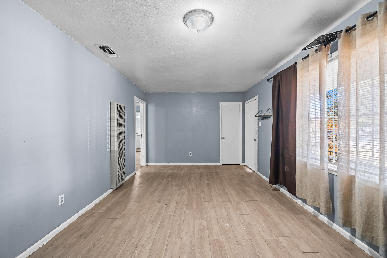 3409 East 17th Street Lubbock, TX 79403 - Photo 3 of 24 a view of hallway with a large window and wooden floor