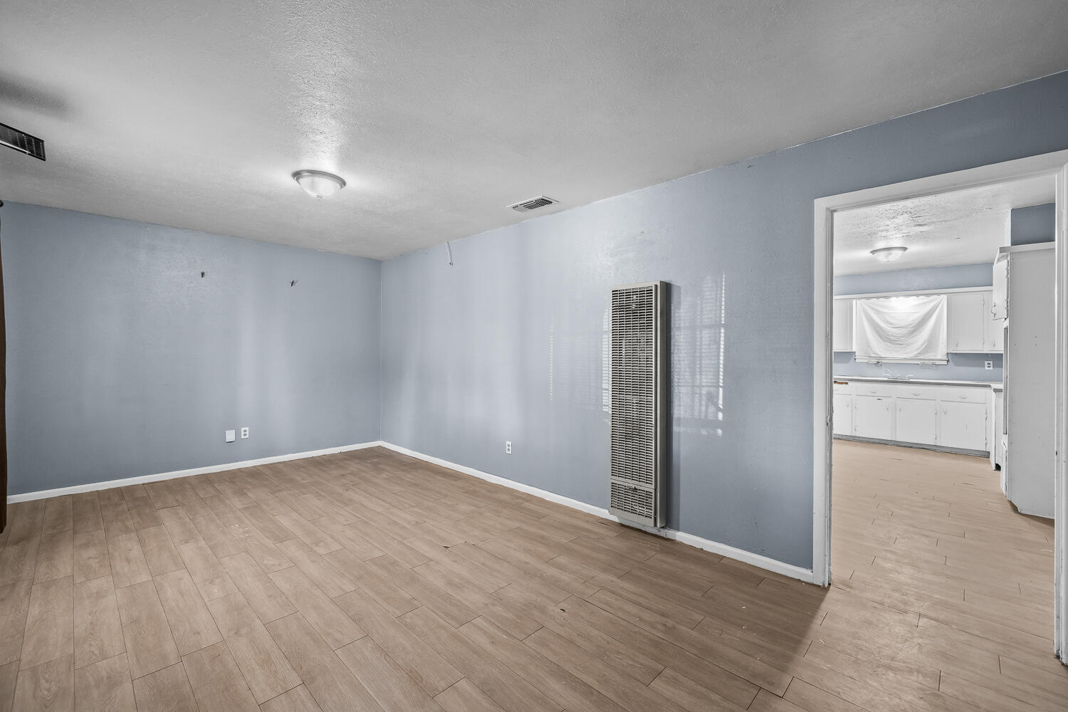 3409 East 17th Street Lubbock, TX 79403 - Photo 4 of 24 wooden floor in an empty room with a window