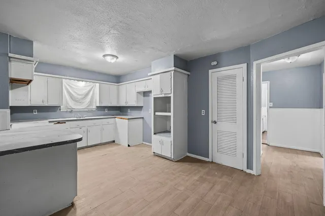a kitchen with granite countertop a sink stove and refrigerator