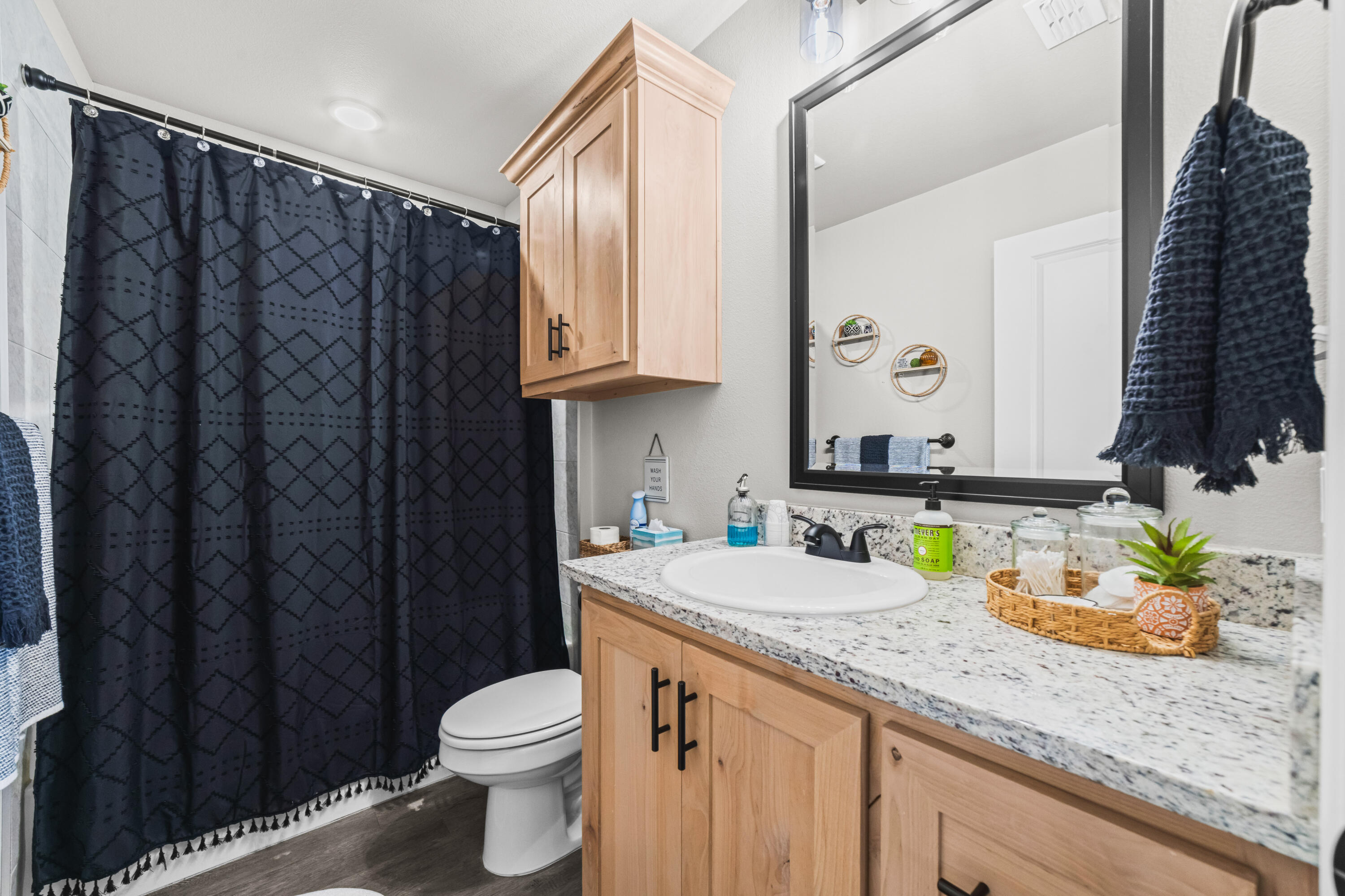 203 Cowboy Lane Wolfforth, TX 79382 - Photo 16 of 21 a bathroom with a granite countertop sink and a mirror