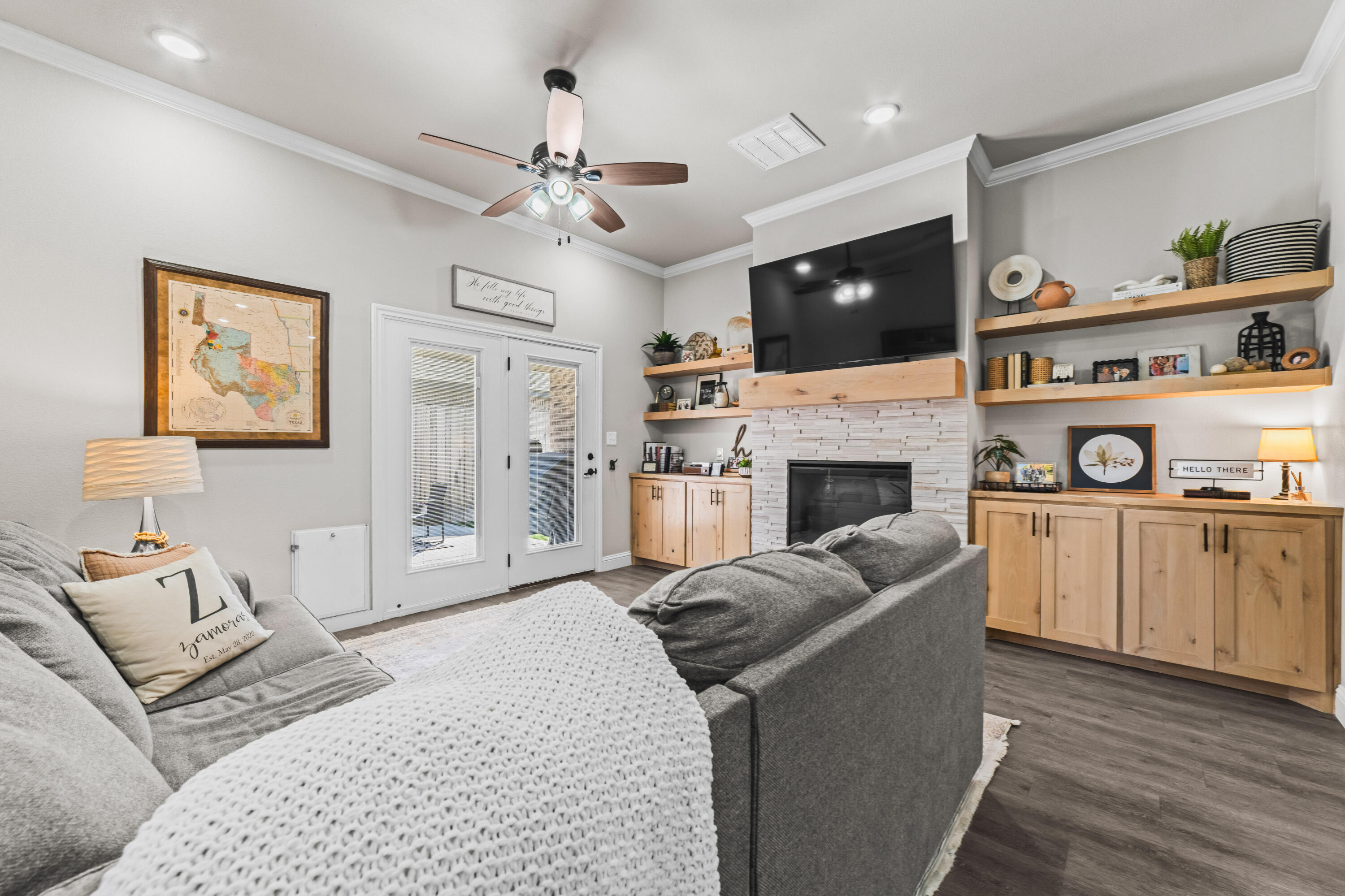 203 Cowboy Lane Wolfforth, TX 79382 - Photo 2 of 21 a living room with furniture a flat screen tv and a fireplace