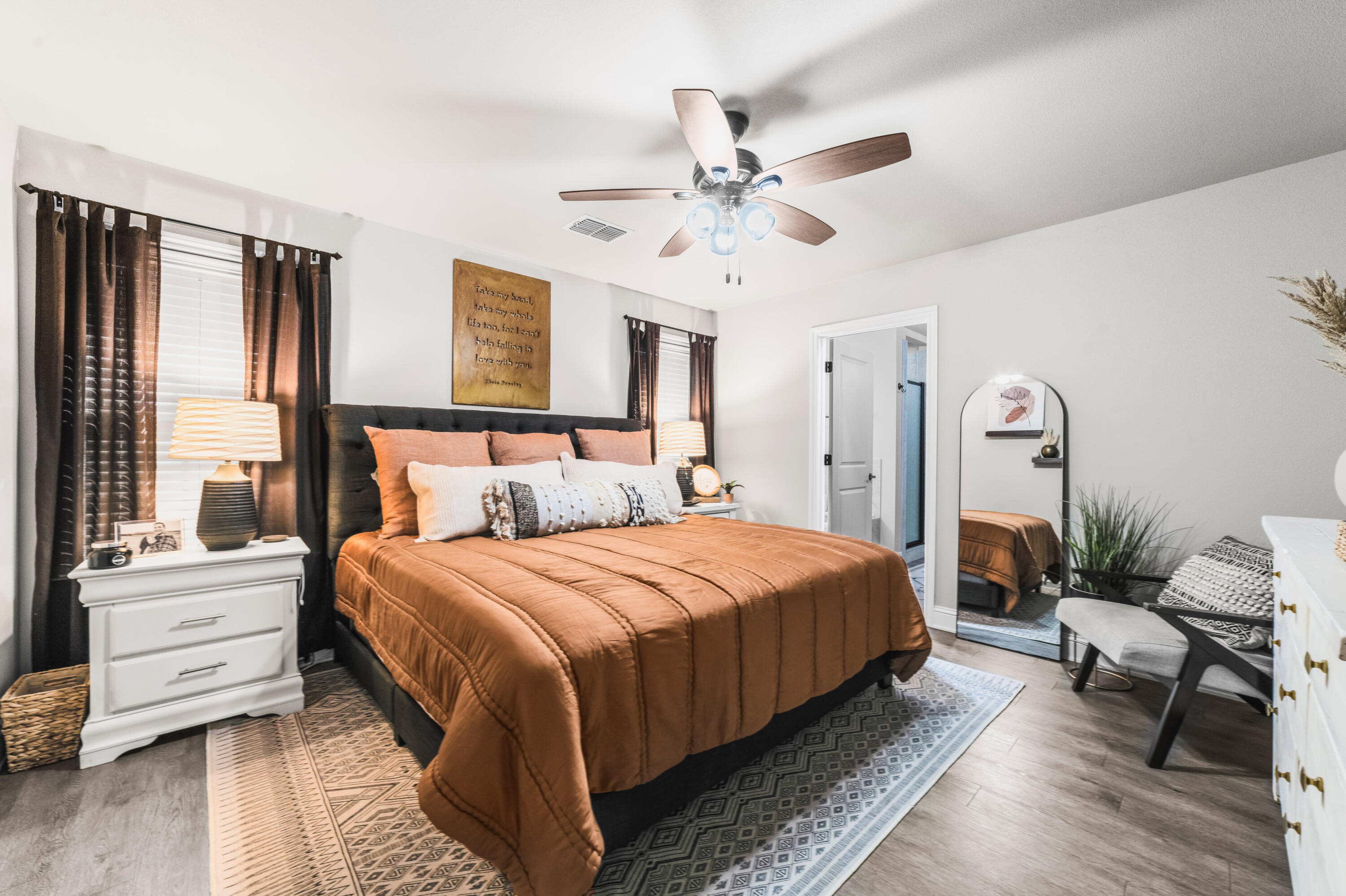 203 Cowboy Lane Wolfforth, TX 79382 - Photo 9 of 21 a bedroom with a large bed and a chandelier