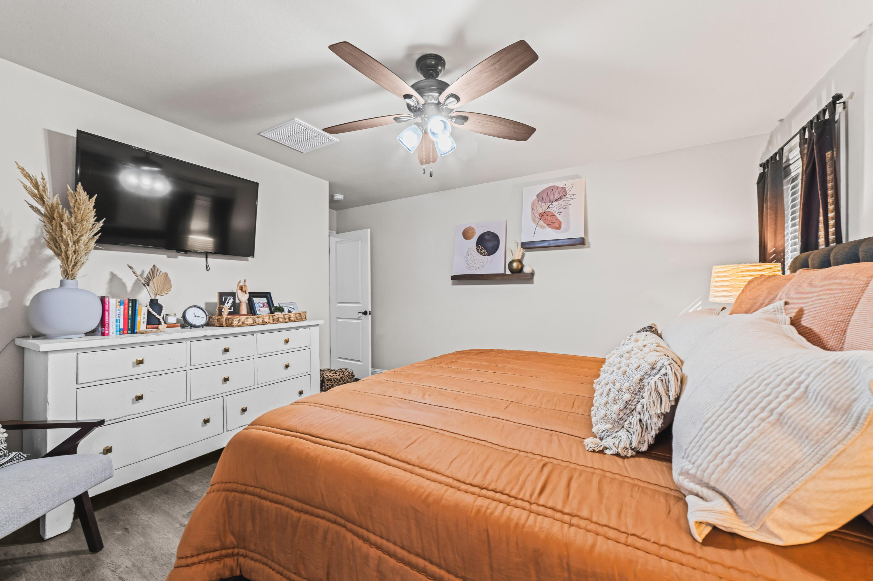 203 Cowboy Lane Wolfforth, TX 79382 - Photo 10 of 21 a bedroom with a bed and a flat screen tv