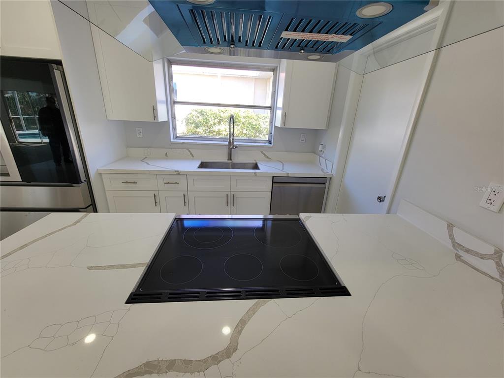 1732 Boca Raton Court Punta Gorda, FL 33950 - Photo 34 of 64 a kitchen with a sink a window and stainless steel appliances