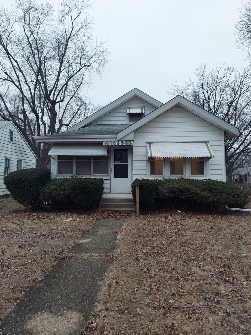 1922 Bruner Street Rockford, IL 61103 - Photo 1 of 13 a front view of a house with garden