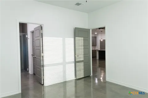 a view of a hallway with closet and a window