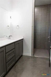 a bathroom with a double vanity sink and mirror