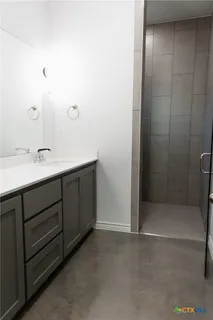 a bathroom with a double vanity sink and mirror