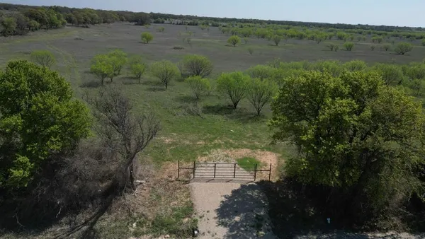 a view of a lake with green field and mountains