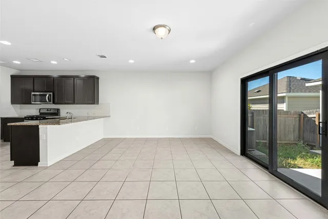 a kitchen with granite countertop a refrigerator and a sink