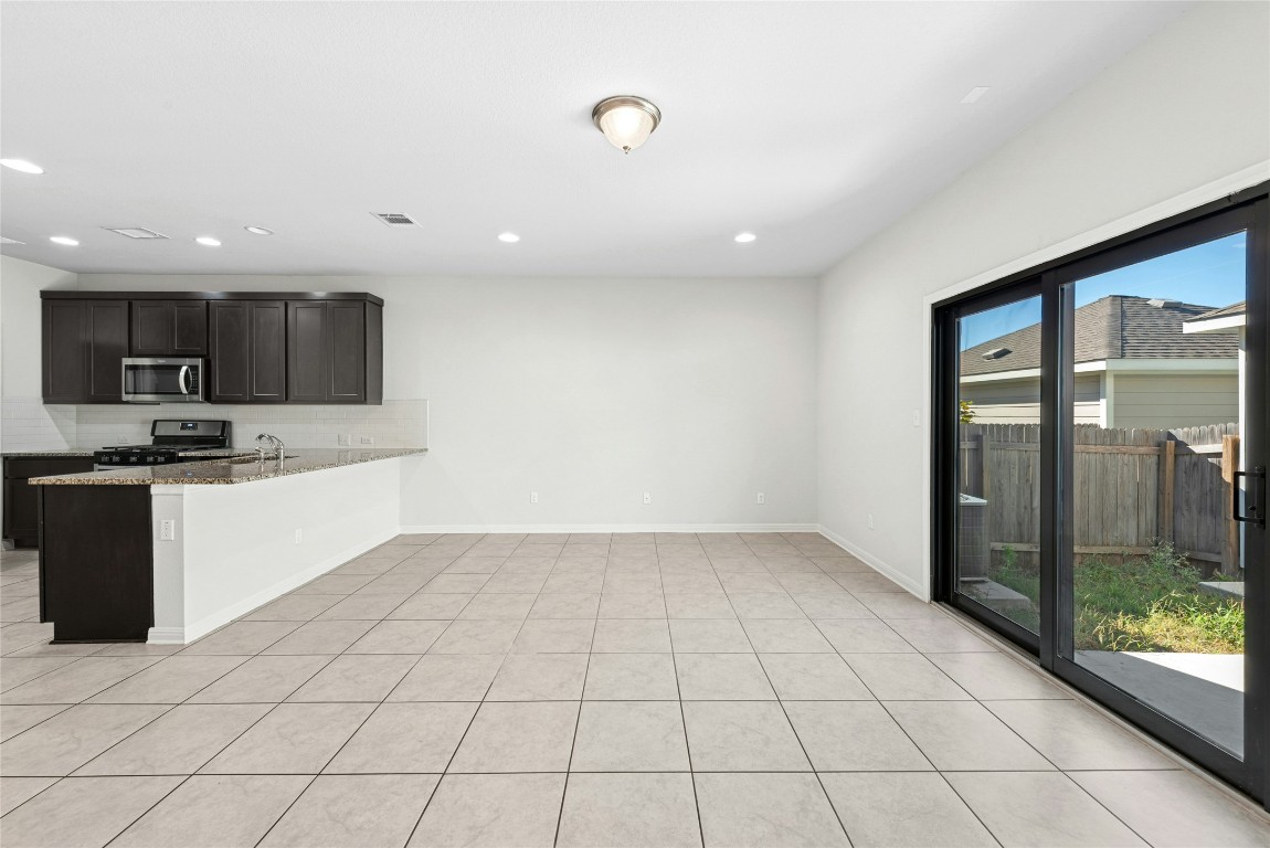 1709 Arendale Drive Leander, TX 78641 - Photo 12 of 36 a large kitchen with a stove a sink and a refrigerator