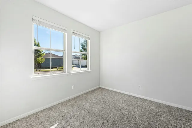 a large kitchen with a stove a sink and a refrigerator