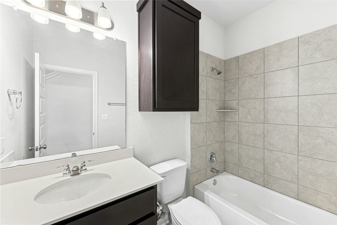 1709 Arendale Drive Leander, TX 78641 - Photo 15 of 36 a bathroom with a sink a toilet and shower