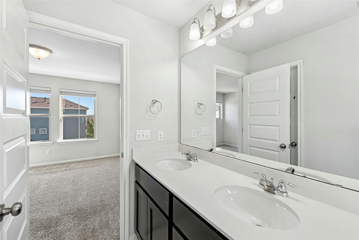 1709 Arendale Drive Leander, TX 78641 - Photo 18 of 36 a bathroom with a sink double vanity and a mirror