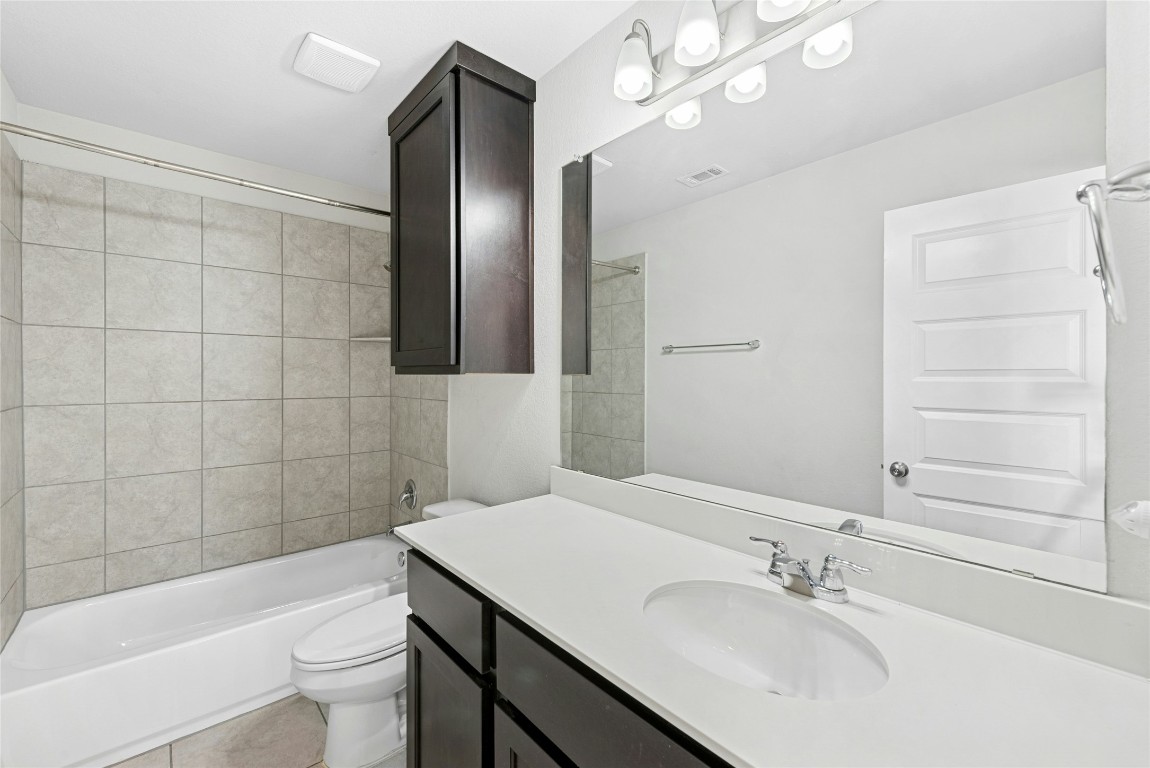 1709 Arendale Drive Leander, TX 78641 - Photo 28 of 36 a bathroom with a bathtub shower sink vanity and toilet