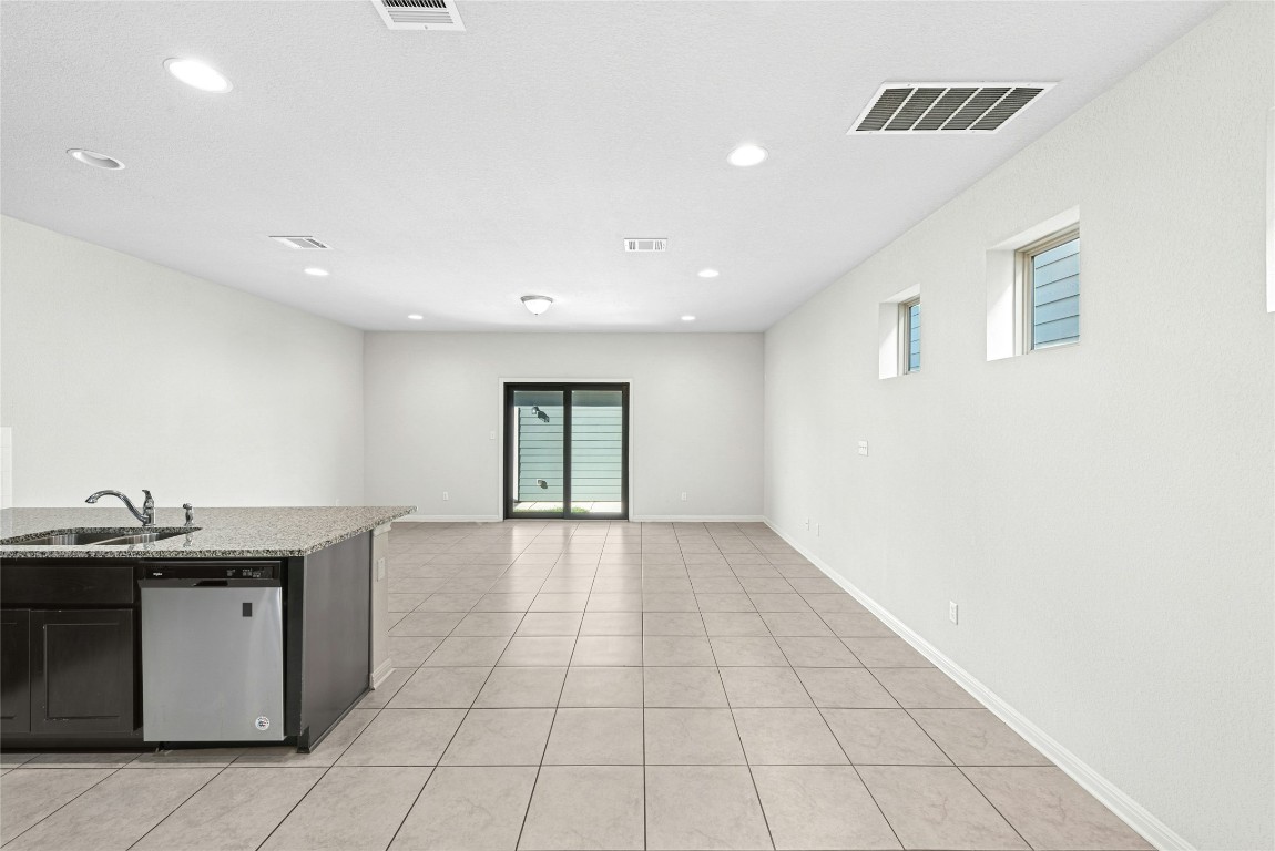 1709 Arendale Drive Leander, TX 78641 - Photo 35 of 36 a view of a kitchen with a sink and dishwasher with wooden floor