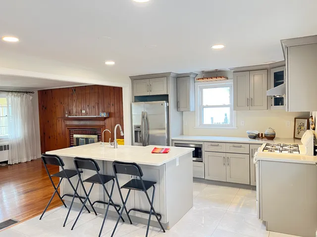 a large kitchen with a table and chairs
