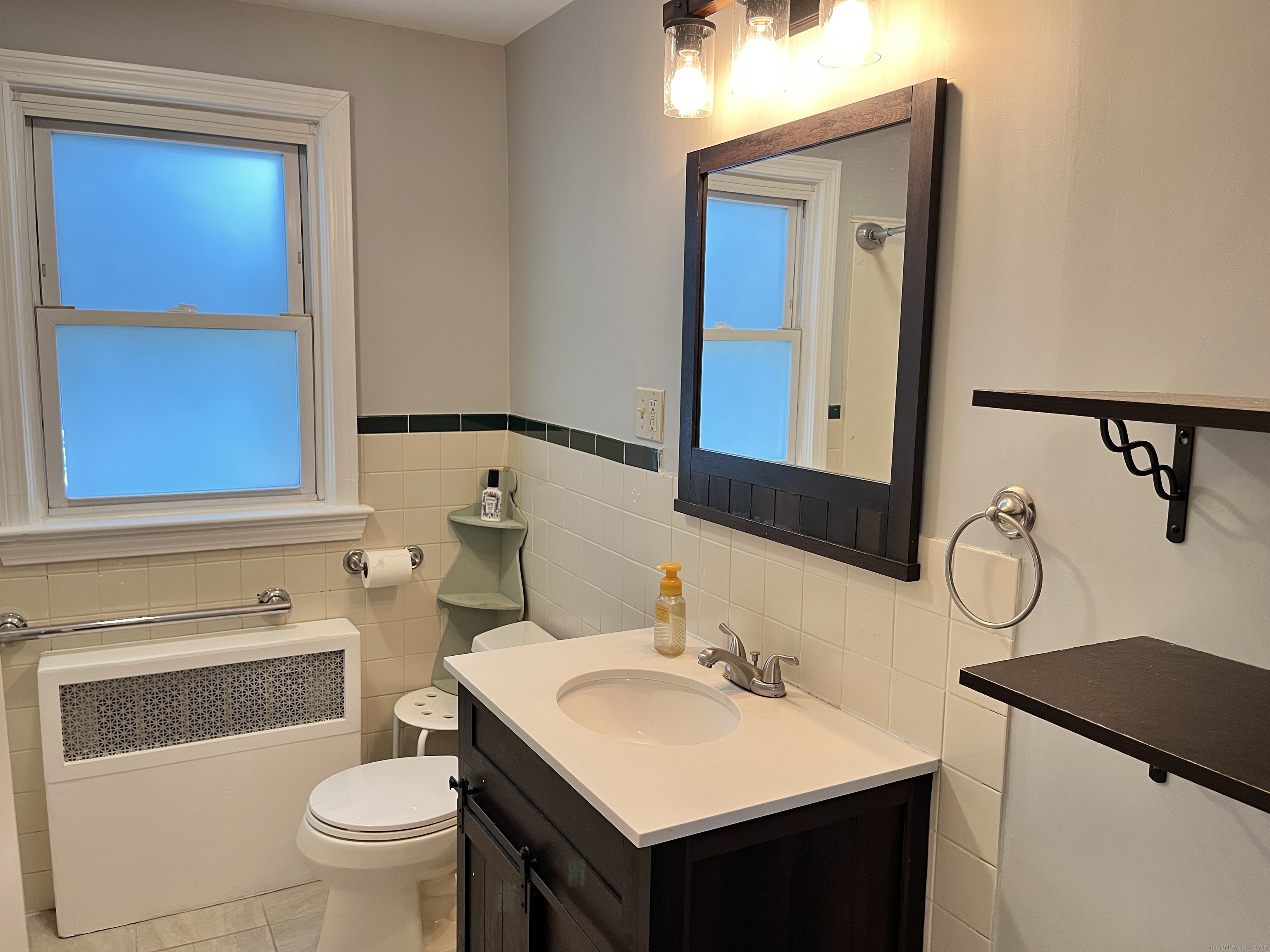 41 Baxter Drive Norwalk, CT 06854 - Photo 4 of 15 a bathroom with a sink vanity mirror and toilet