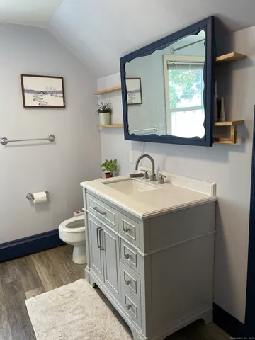 a bathroom with a sink toilet and mirror